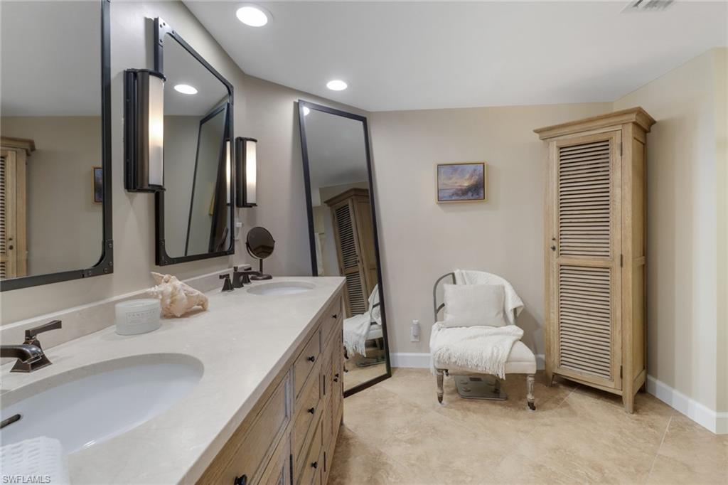 25 Bluebill Avenue, Unit A906 Naples, FL 34108 - Photo 26 of 40 a bathroom with a sink double vanity and a mirror