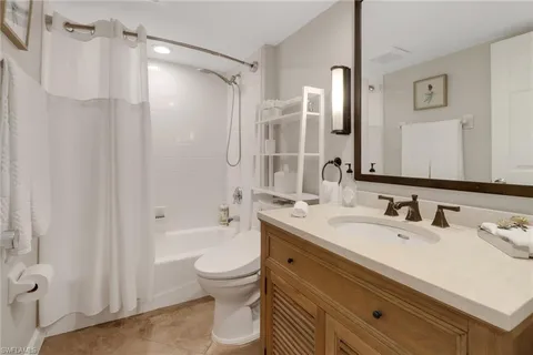 a bathroom with a mirror and a shower