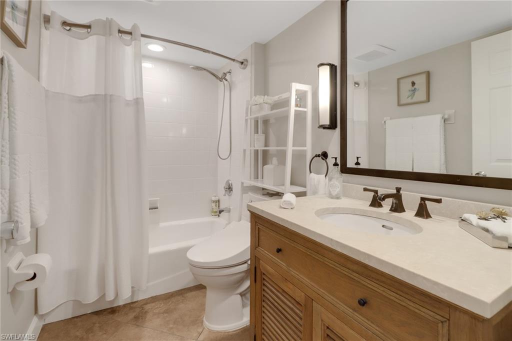 25 Bluebill Avenue, Unit A906 Naples, FL 34108 - Photo 30 of 40 a bathroom with a sink a toilet and shower