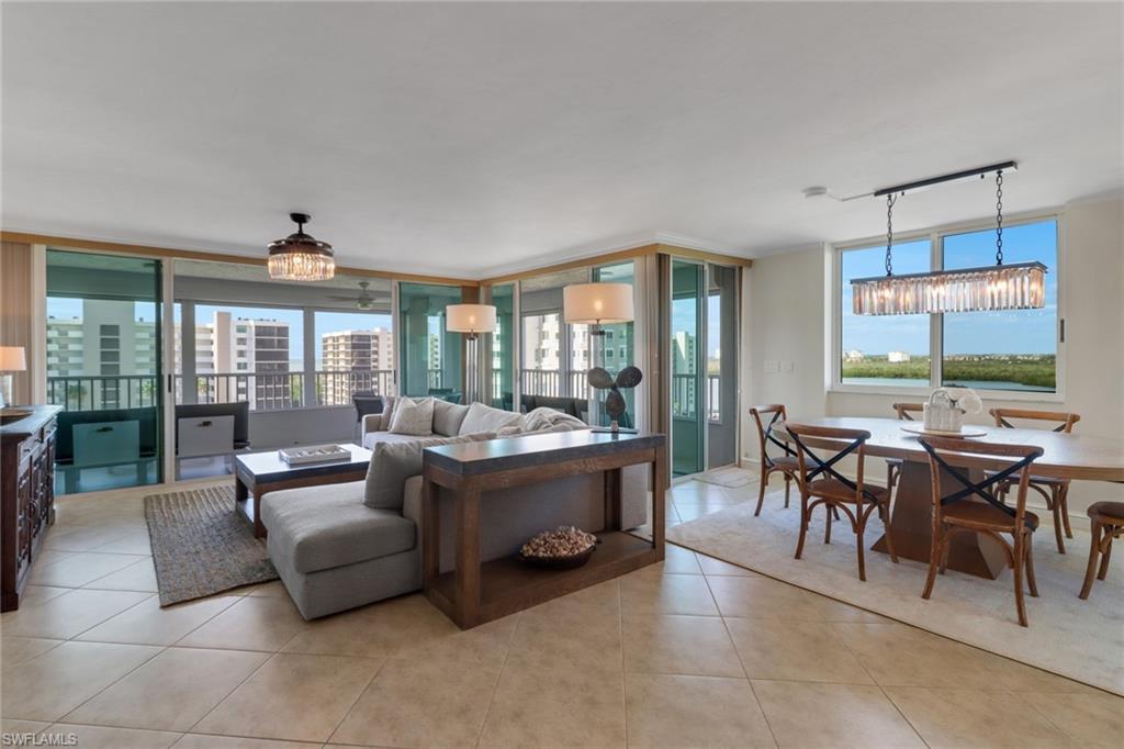 25 Bluebill Avenue, Unit A906 Naples, FL 34108 - Photo 5 of 40 a large living room with furniture and a large window