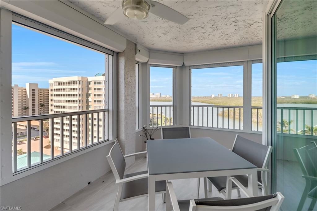 25 Bluebill Avenue, Unit A906 Naples, FL 34108 - Photo 8 of 40 Main lanai wraps around two sides, featuring views of both the Gulf and canal. Watching boats come and go is beautiful!