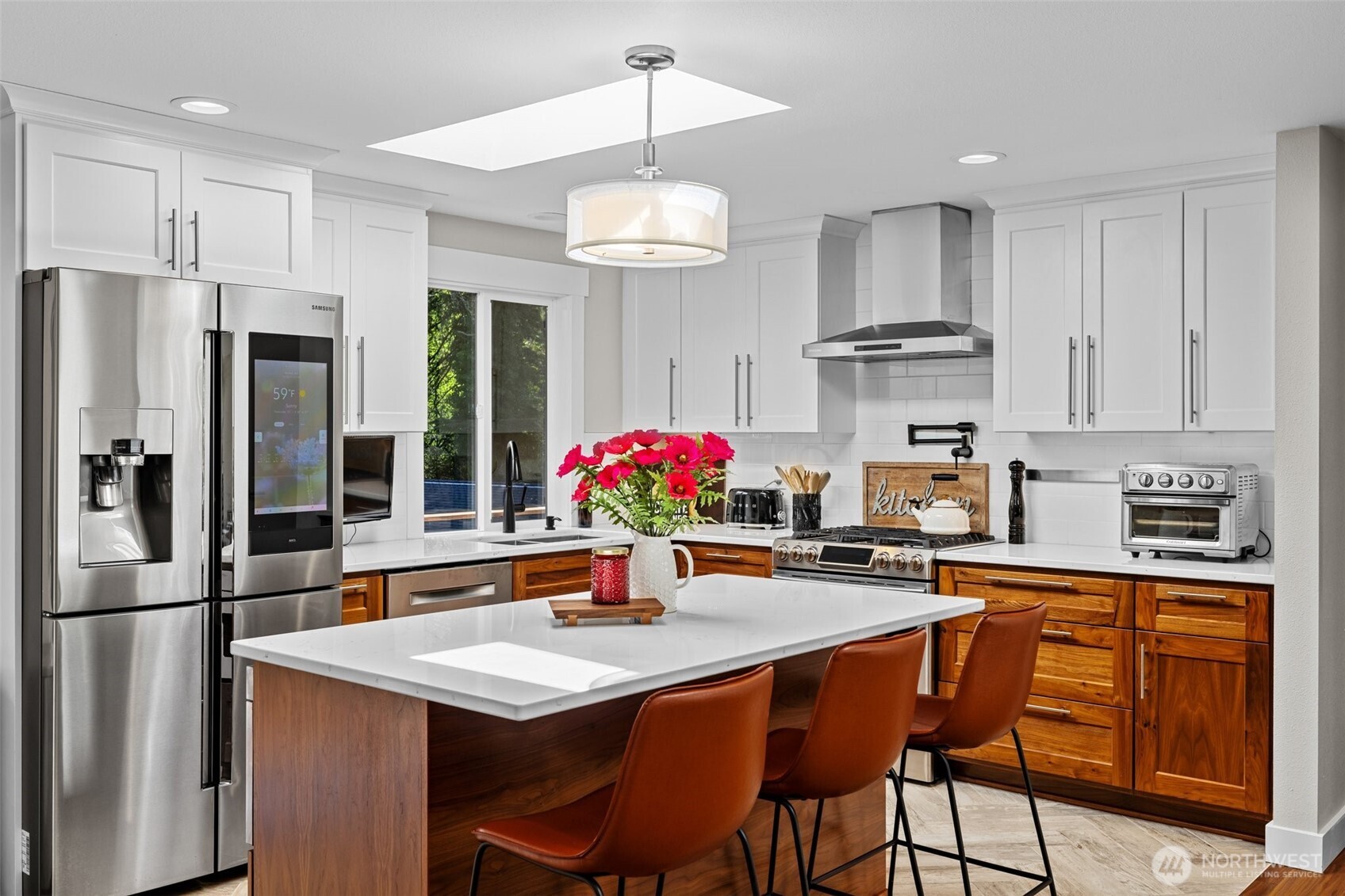 106 234th Place Southeast Bothell, WA 98021 - Photo 11 of 38 a kitchen with stainless steel appliances granite countertop a dining table chairs refrigerator and cabinets