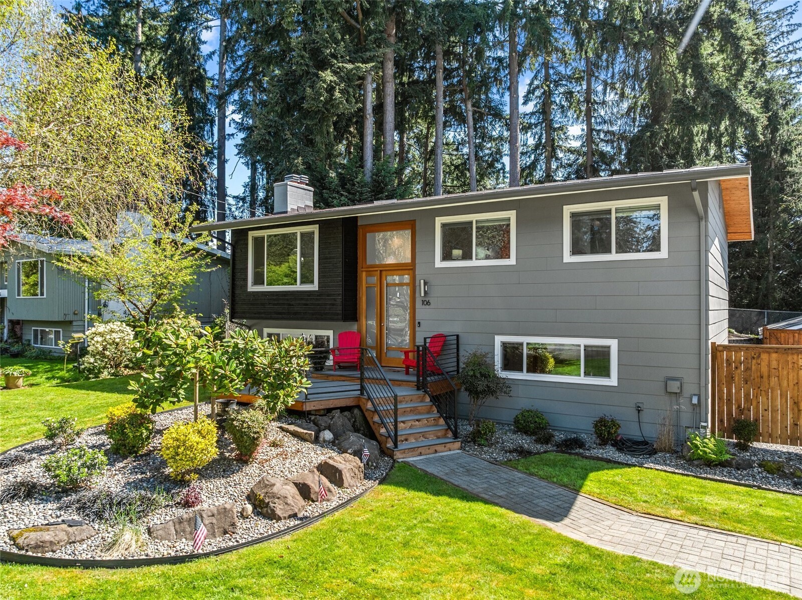 a view of a house with backyard and sitting area