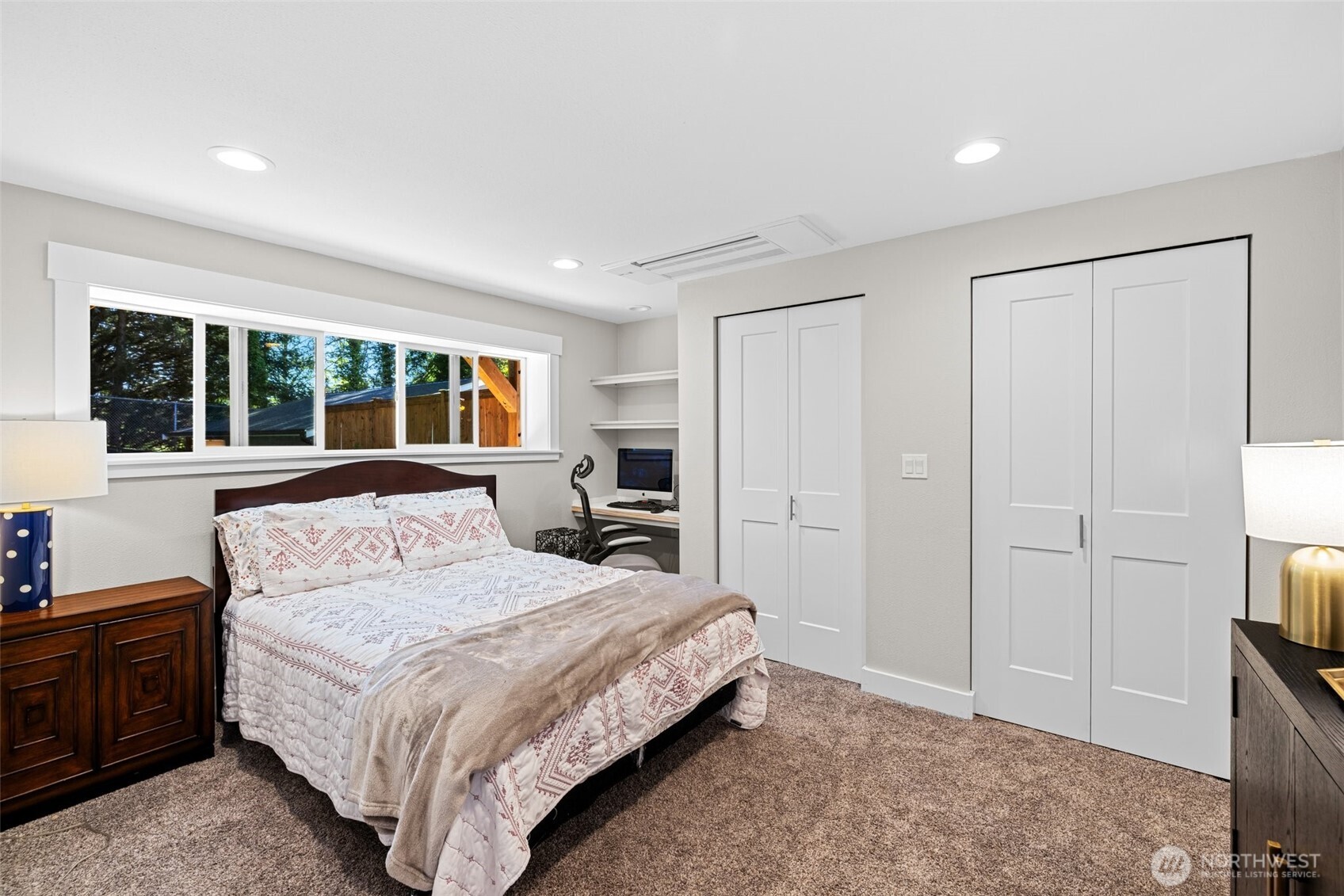 106 234th Place Southeast Bothell, WA 98021 - Photo 24 of 38 a bedroom with a large bed and a flat tv screen