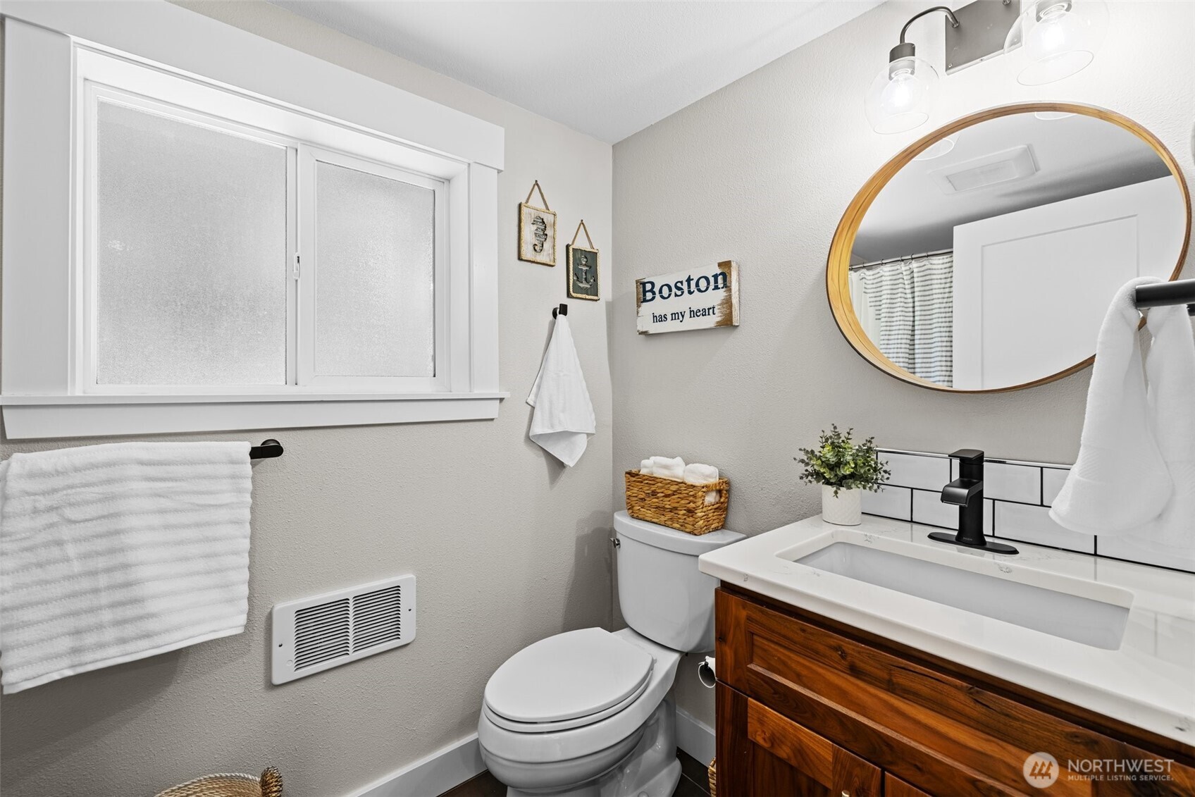 106 234th Place Southeast Bothell, WA 98021 - Photo 25 of 38 a bathroom with a toilet a sink and mirror