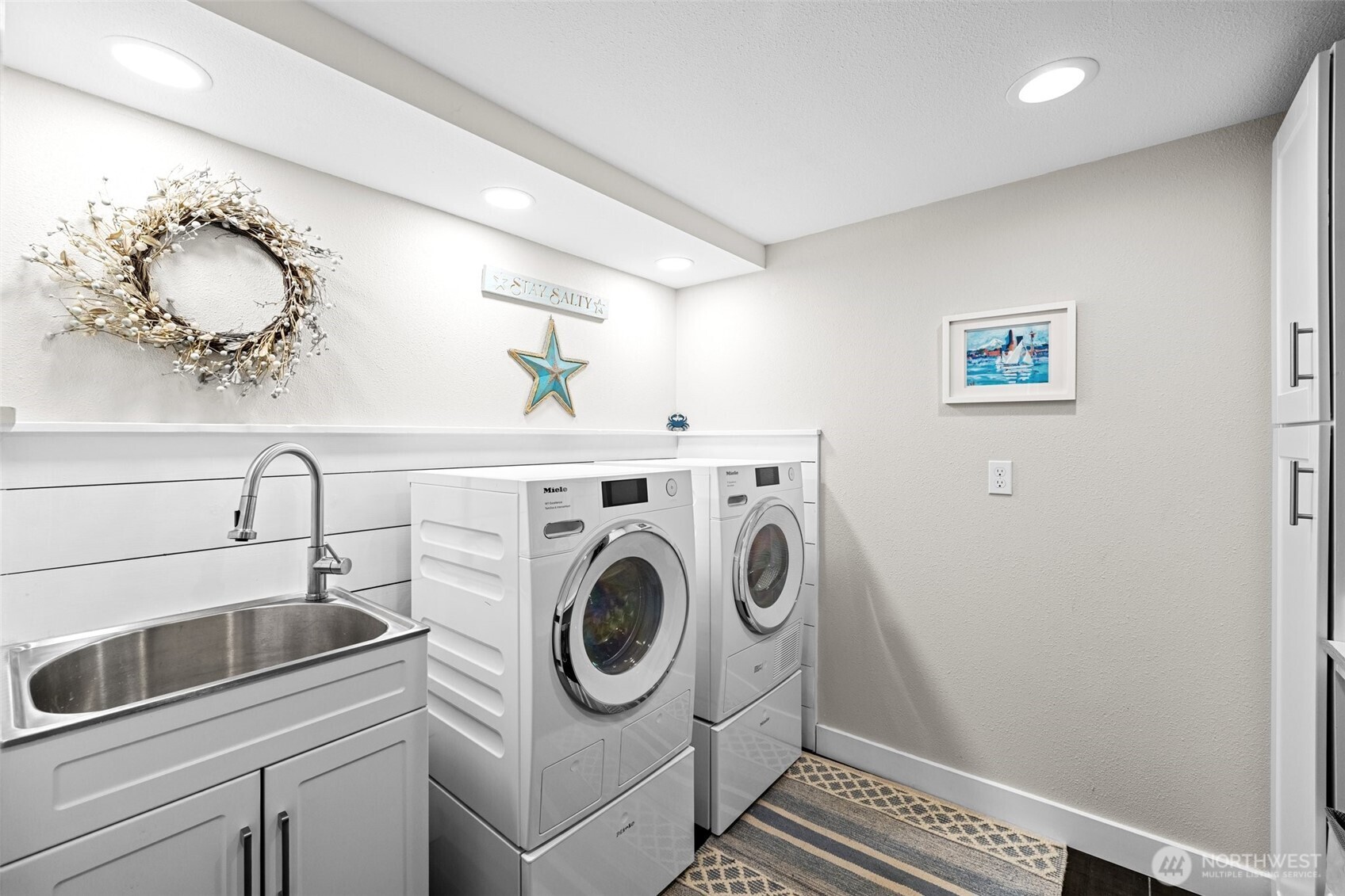 106 234th Place Southeast Bothell, WA 98021 - Photo 27 of 38 a utility room with sink dryer and washer