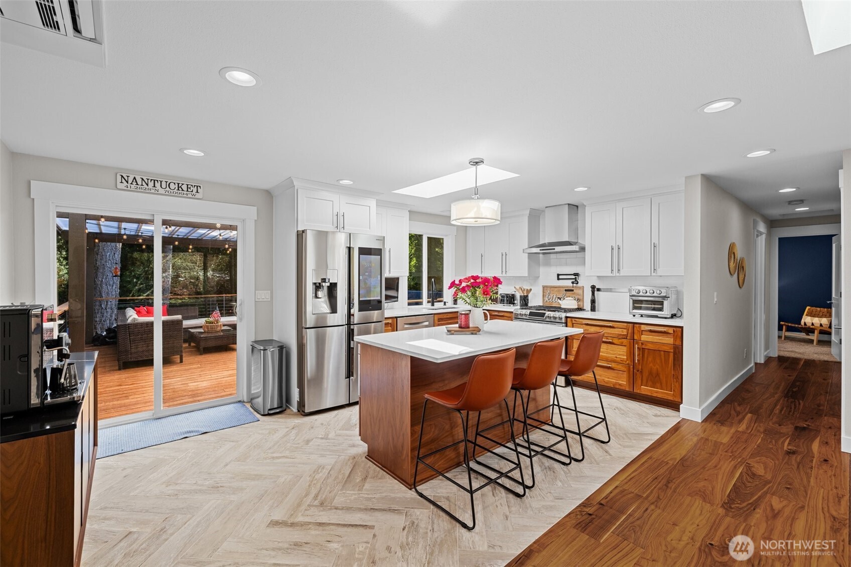 106 234th Place Southeast Bothell, WA 98021 - Photo 10 of 38 a kitchen with stainless steel appliances kitchen island granite countertop a refrigerator a stove a sink a dining table and chairs with wooden floor