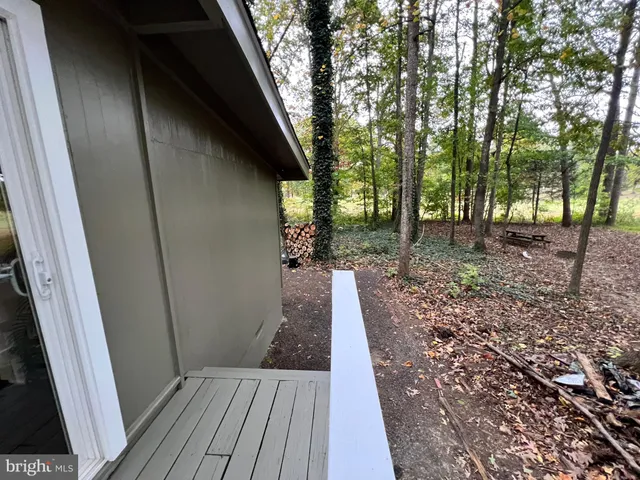 a view of a house with a yard and tree in it