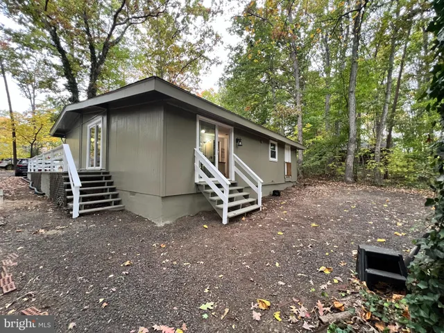 a backyard of a house with barbeque oven