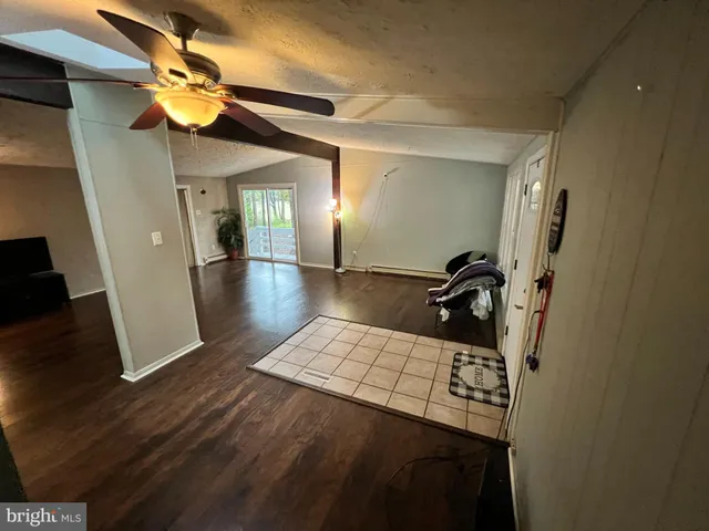 a dining room with furniture and a floor to ceiling window