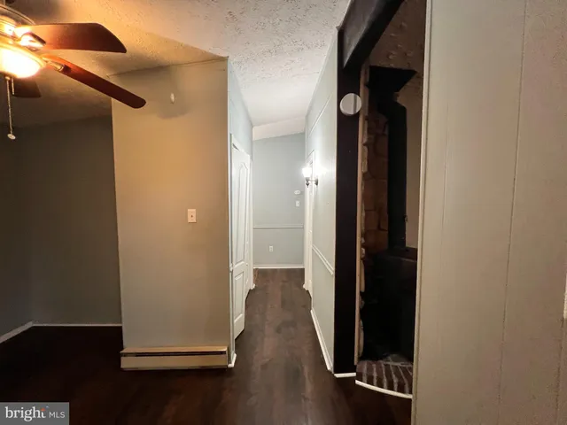 a white refrigerator freezer and a stove sitting inside of a kitchen