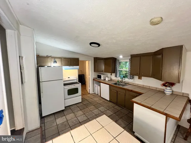 a view of a livingroom with furniture and hardwood floor