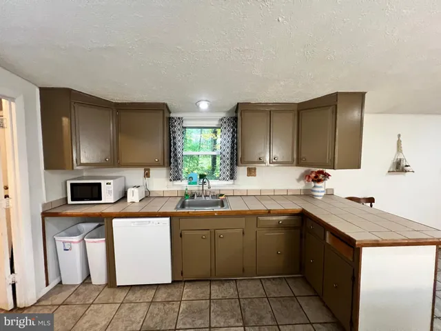 a bathroom with a toilet a sink and shower