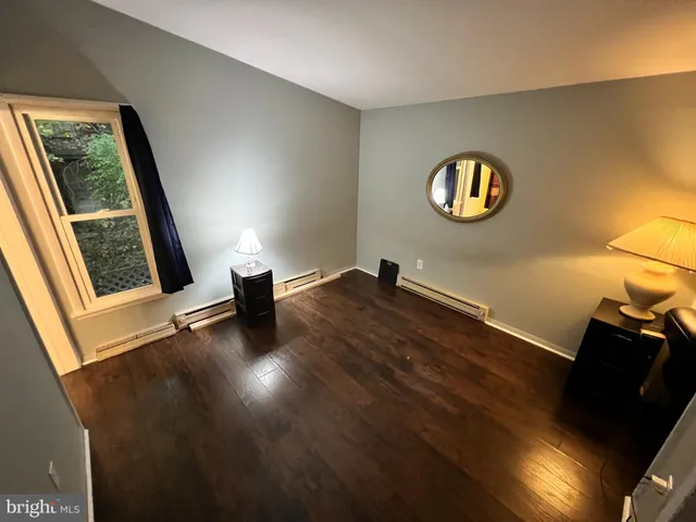 a living room with furniture and a lamp