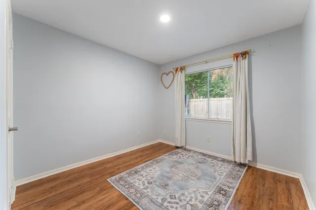 a view of room with window and wooden floor
