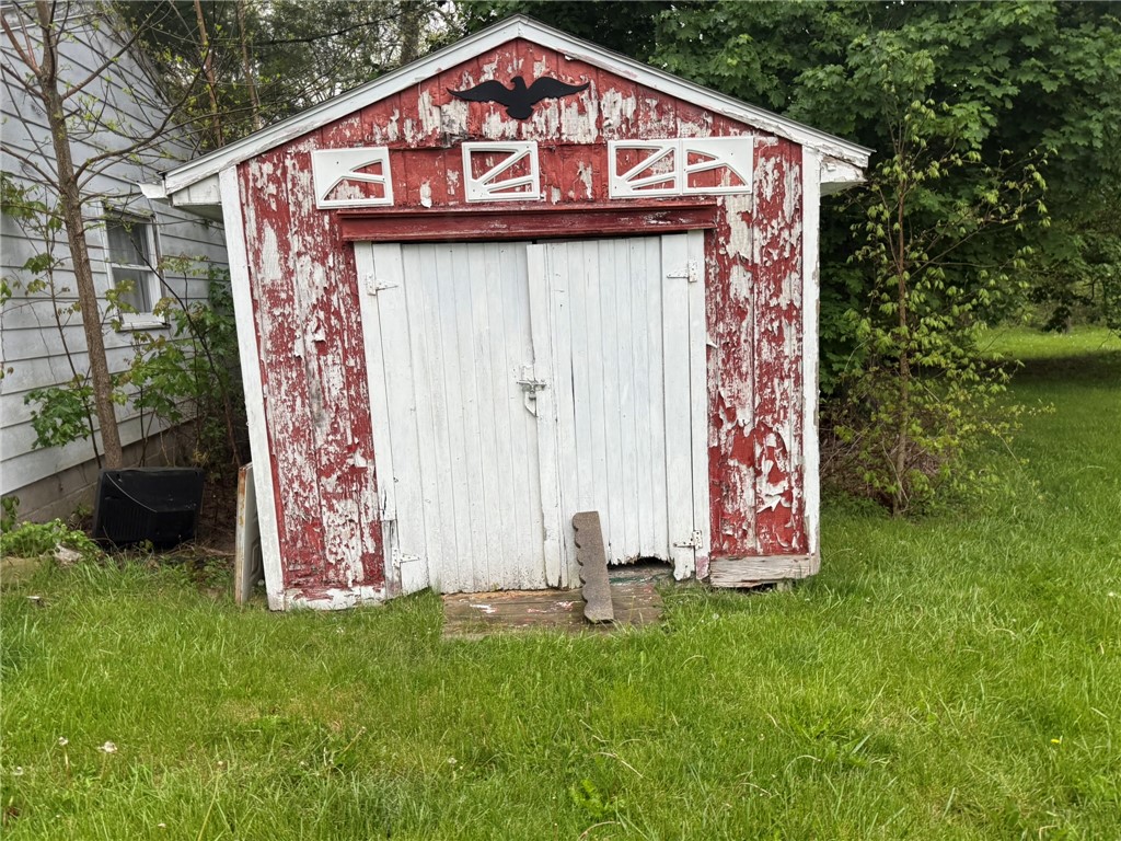 121 State Route, Unit 10570 New Paris, OH 45347 - Photo 7 of 8 This quaint shed offers rustic charm and practical outdoor storage solutions.