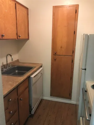 a utility room with wooden floor washer and dryer