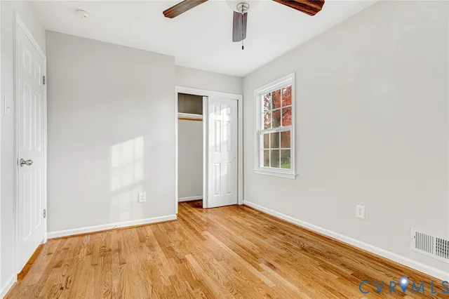 a view of an entryway with wooden floor and door