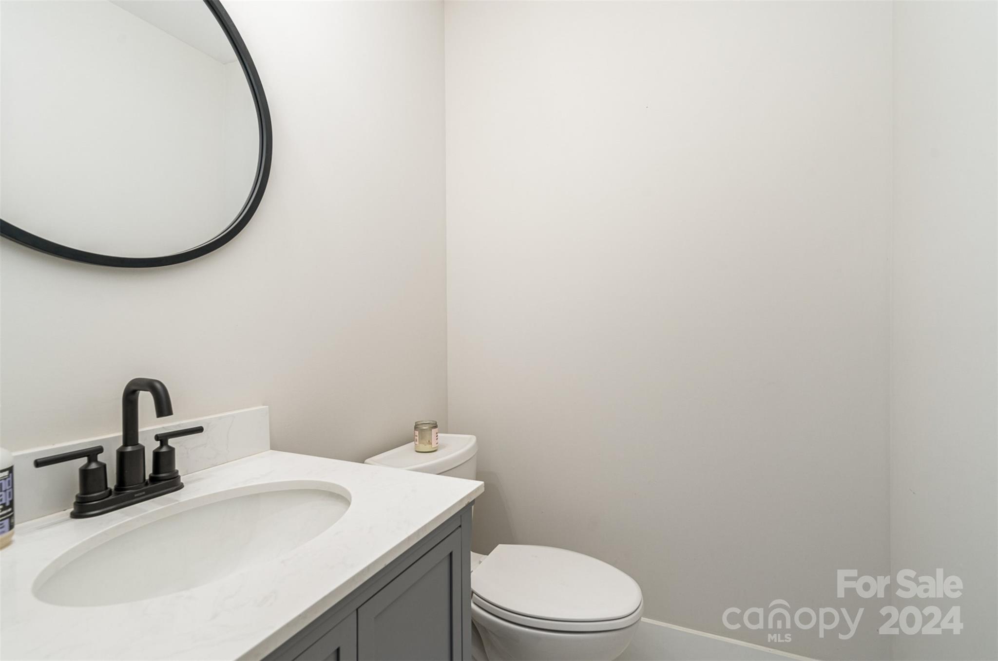 5335 Valley Forge Road Charlotte, NC 28210 - Photo 14 of 29 a bathroom with a sink a toilet and a mirror