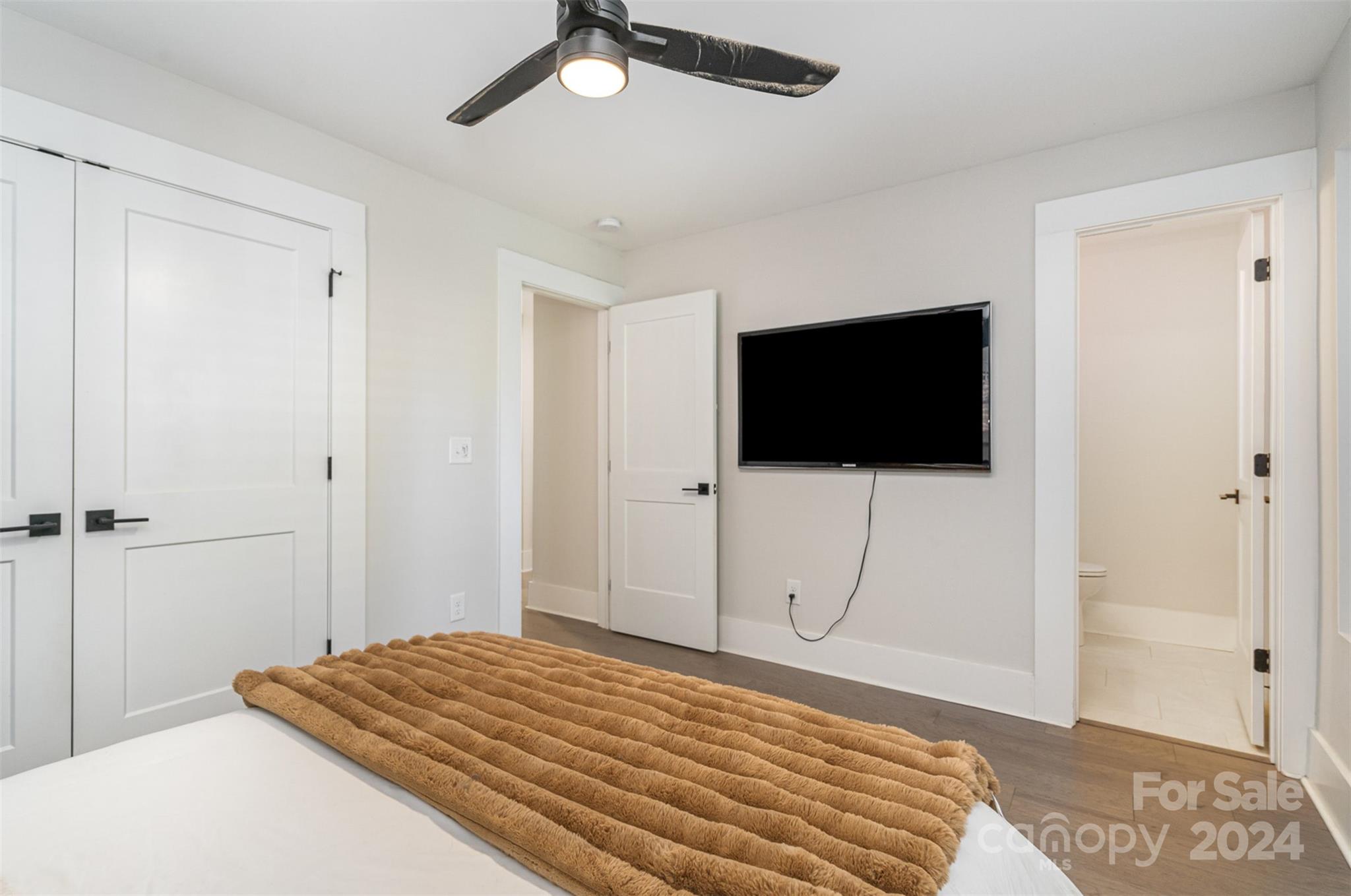 5335 Valley Forge Road Charlotte, NC 28210 - Photo 20 of 29 a bedroom with a bed and a flat screen tv