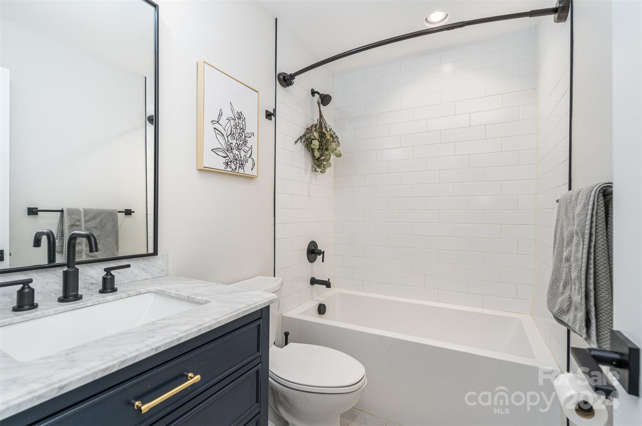 5335 Valley Forge Road Charlotte, NC 28210 - Photo 23 of 29 a bathroom with a granite countertop sink a toilet and shower