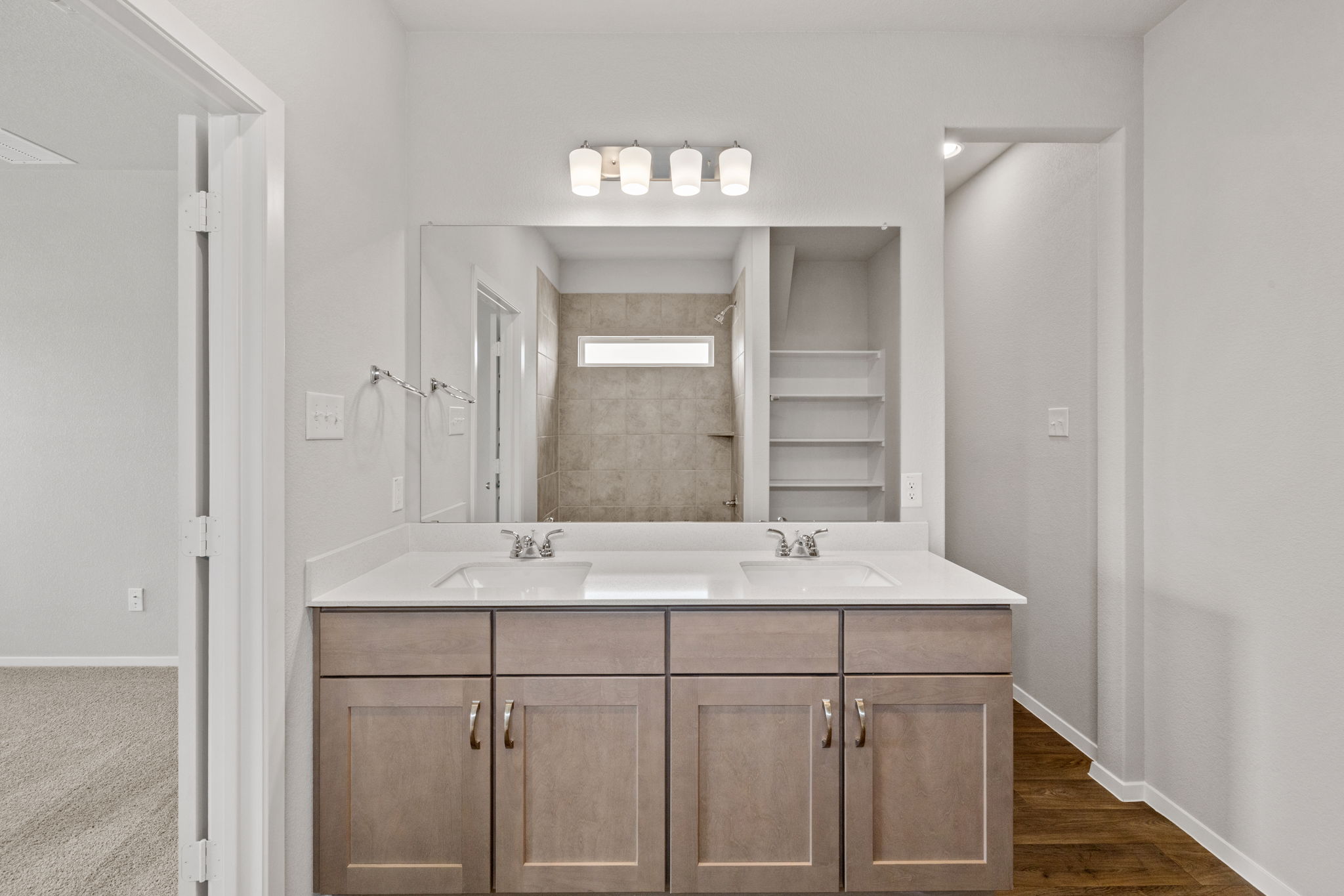 2460 Winding Creek Road Kyle, TX 78640 - Photo 12 of 20 Double vanity with ample storage and a generously sized mirror anchors this practical, well-lit bathroom.