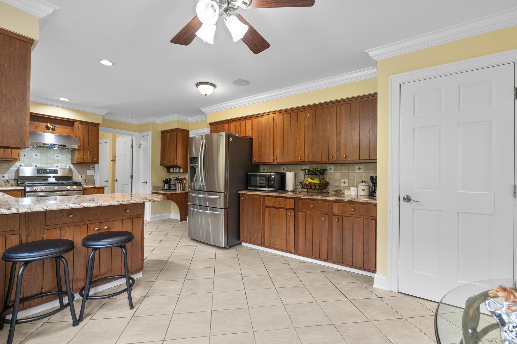 14 East Gate Road Danbury, CT 06811 - Photo 18 of 40 a kitchen with stainless steel appliances a refrigerator and microwave