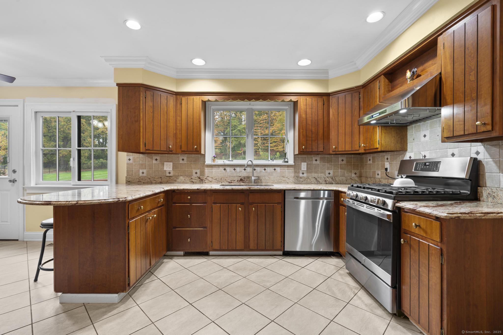 14 East Gate Road Danbury, CT 06811 - Photo 19 of 40 a kitchen with stainless steel appliances granite countertop a stove a sink and a microwave