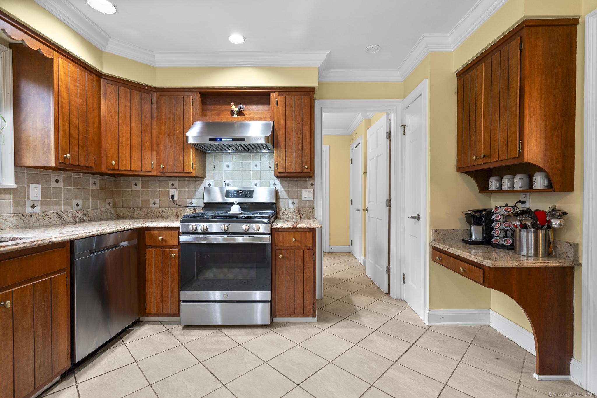 14 East Gate Road Danbury, CT 06811 - Photo 20 of 40 a kitchen with stainless steel appliances granite countertop a stove a sink and a refrigerator