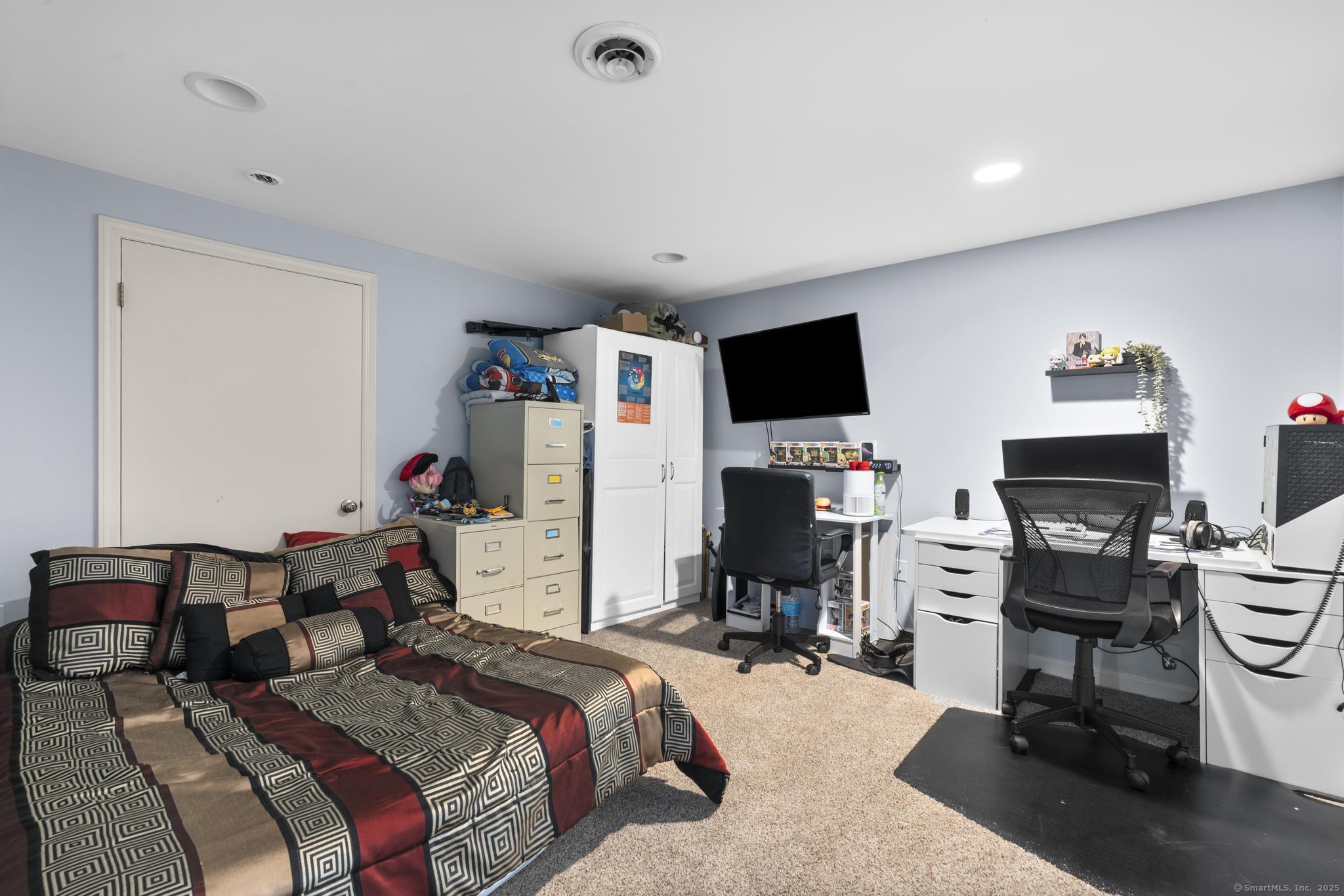 14 East Gate Road Danbury, CT 06811 - Photo 30 of 40 a bedroom with a bed and a flat screen tv