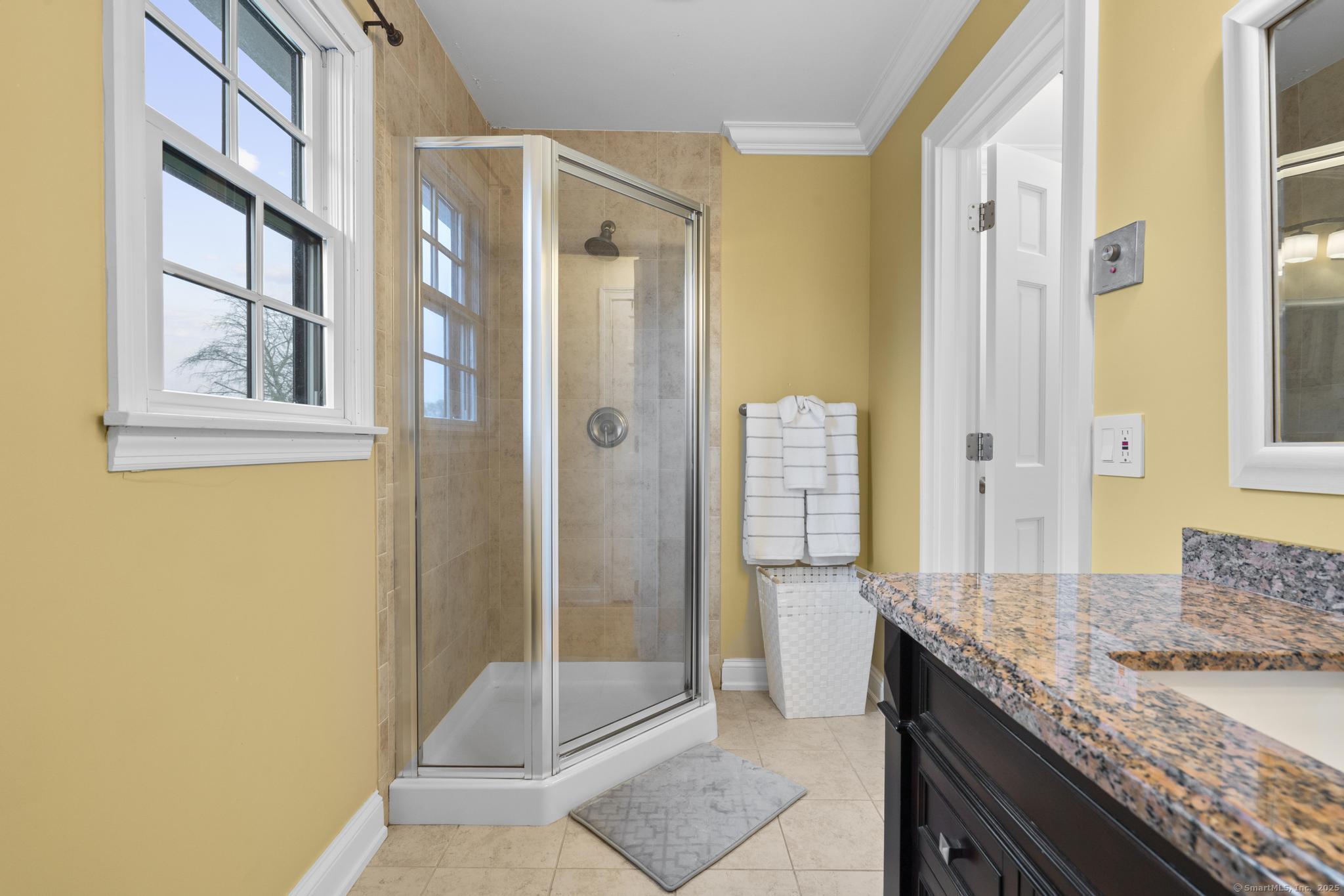 14 East Gate Road Danbury, CT 06811 - Photo 33 of 40 a bathroom with a granite countertop shower a sink and a mirror
