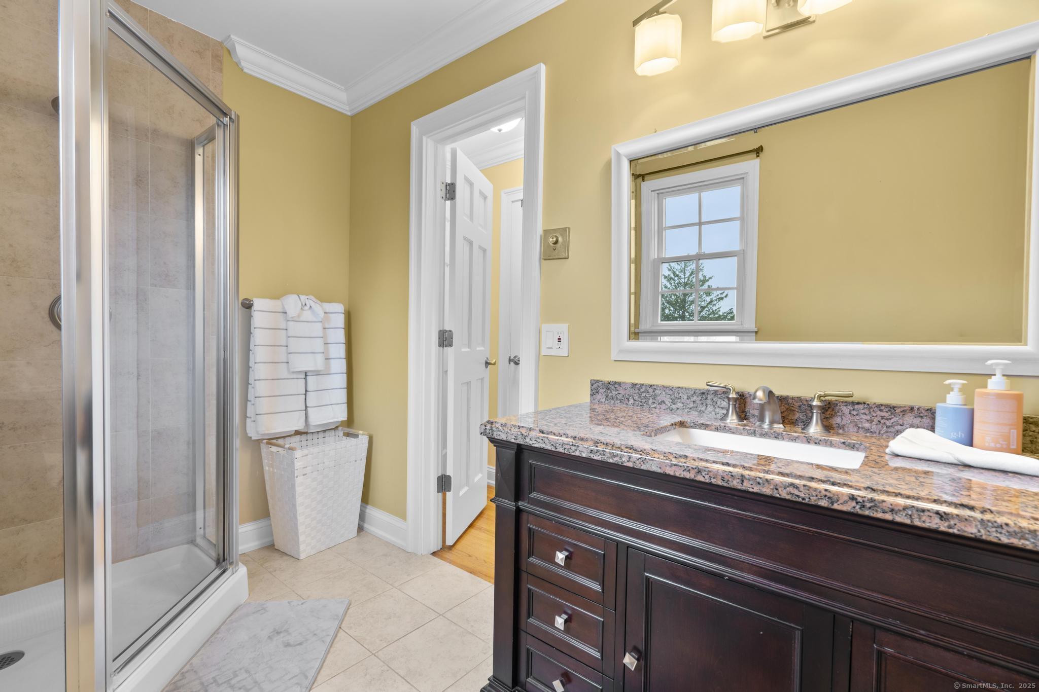 14 East Gate Road Danbury, CT 06811 - Photo 34 of 40 a bathroom with a granite countertop sink and a mirror