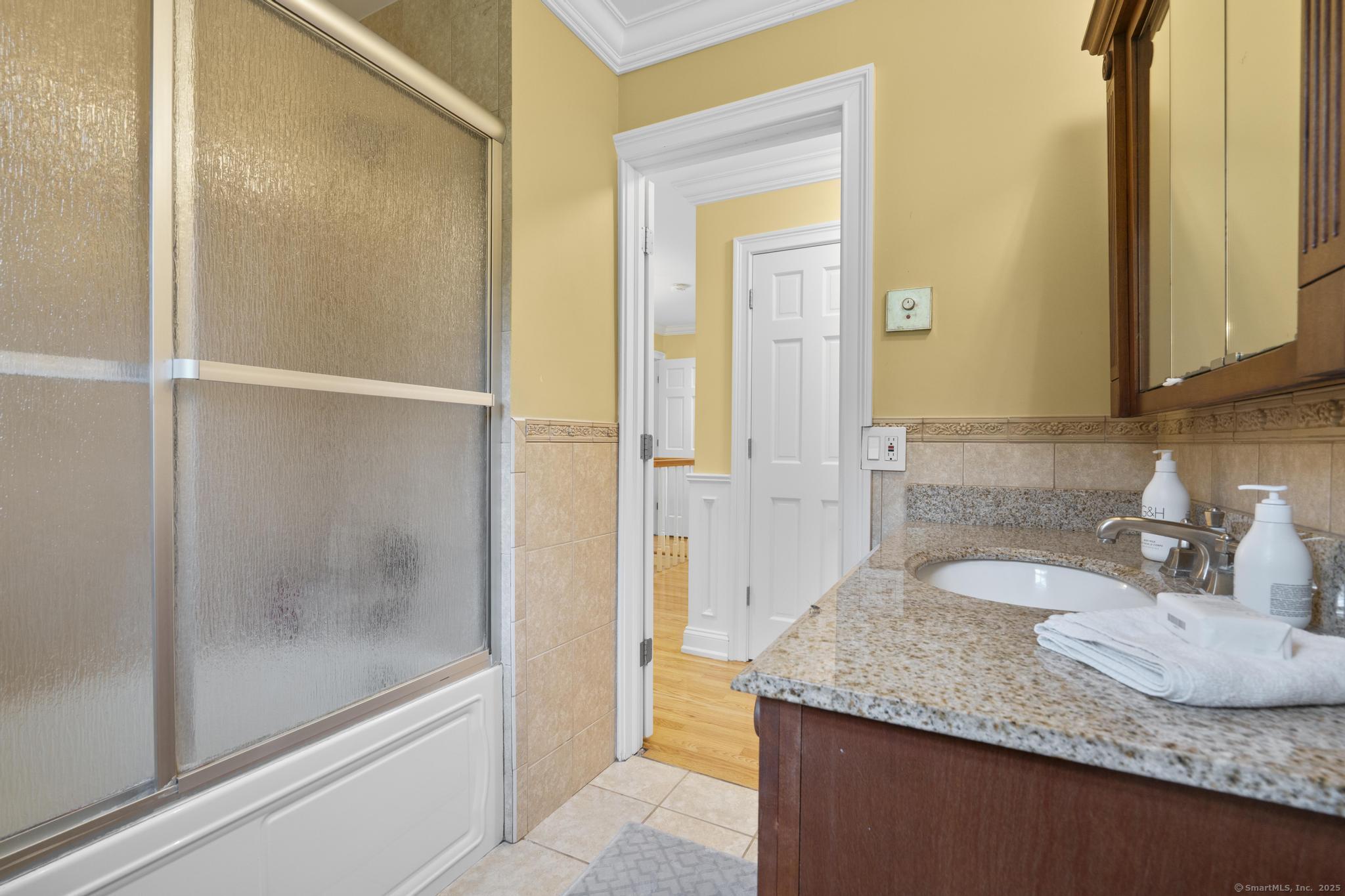 14 East Gate Road Danbury, CT 06811 - Photo 37 of 40 a bathroom with a granite countertop sink and a mirror