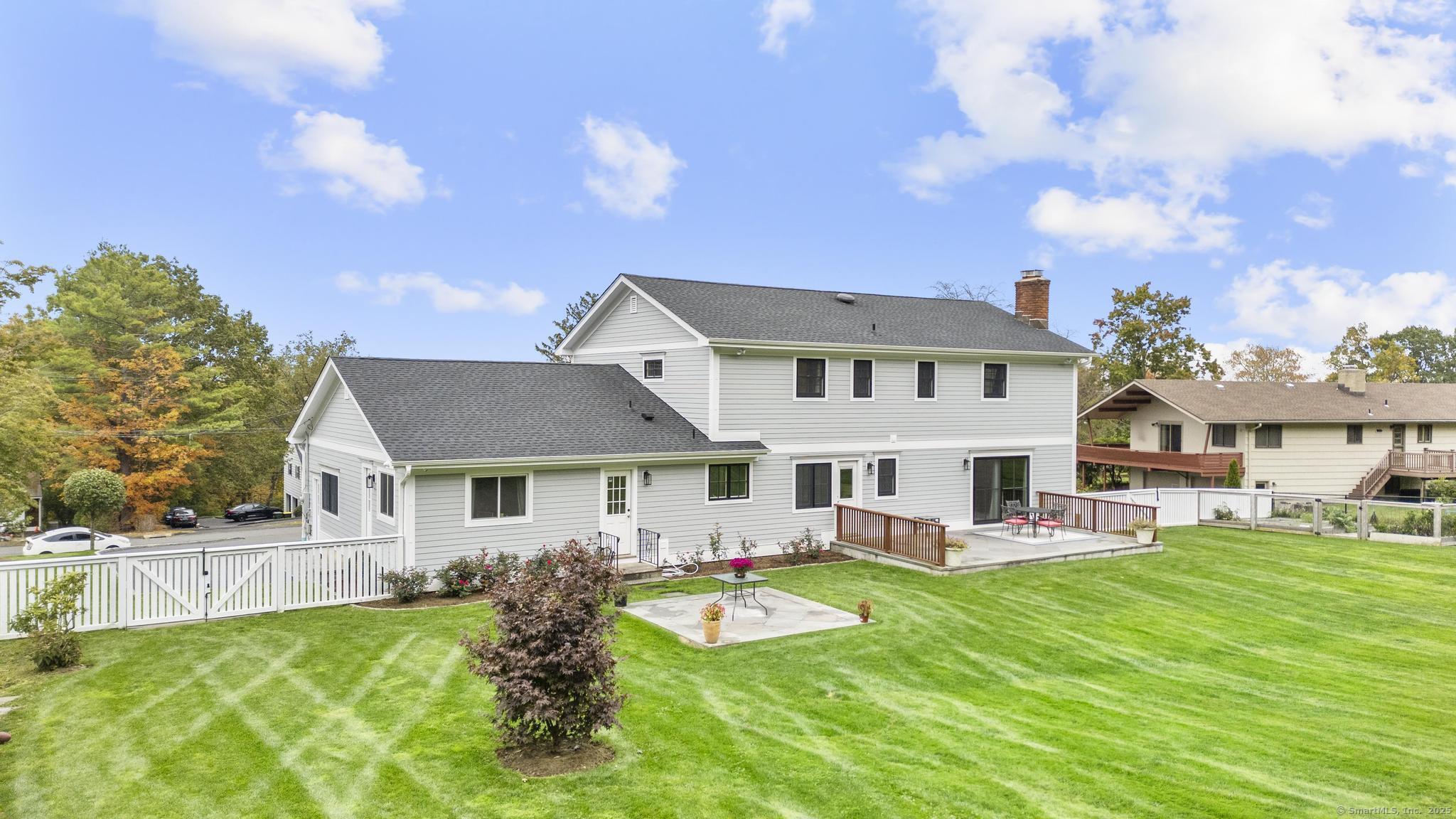 14 East Gate Road Danbury, CT 06811 - Photo 5 of 40 a view of a house with a big yard potted plants and a large tree