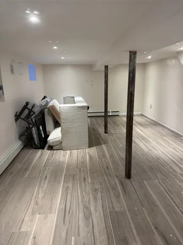 a bed room with a bed and a view of kitchen