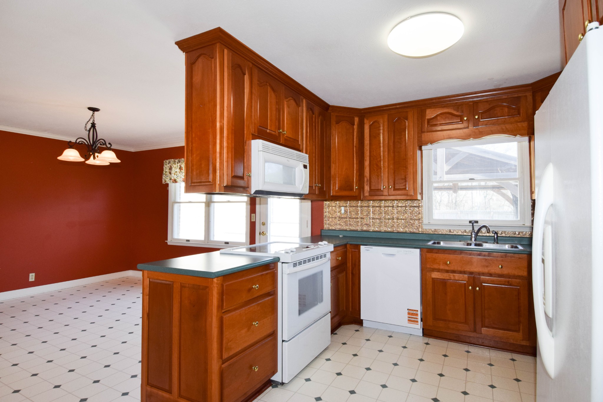 1059 Robertson Road Gallatin, TN 37066 - Photo 30 of 84 a kitchen with stainless steel appliances a sink a stove a refrigerator and cabinets