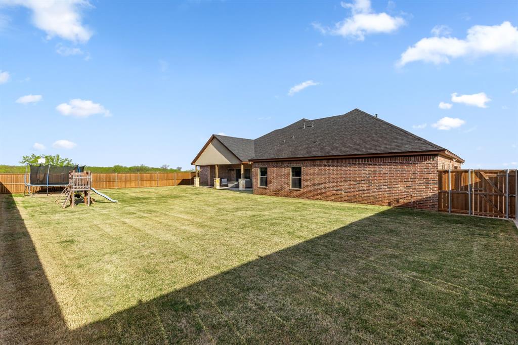 515 Sales Road Windthorst, TX 76389 - Photo 33 of 34 a view of an house with backyard and outdoor space