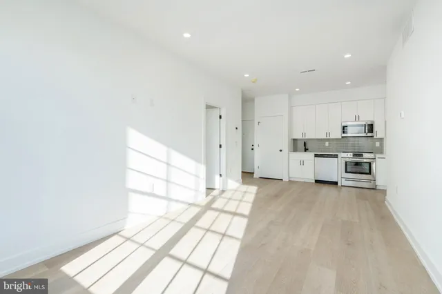 a view of a kitchen with wooden floor