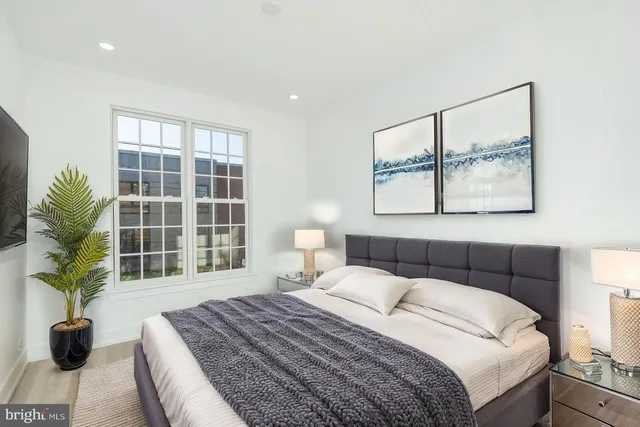 a bedroom with a large bed and a large window