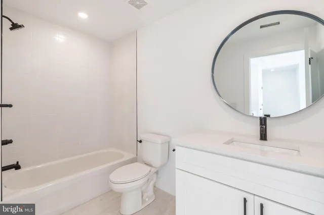 a bathroom with a toilet sink and a mirror