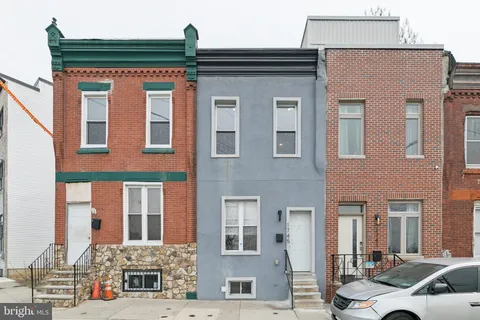 a front view of a residential apartment building with a yard