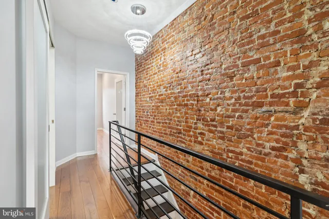 a view of a room with wooden floor and a bathroom