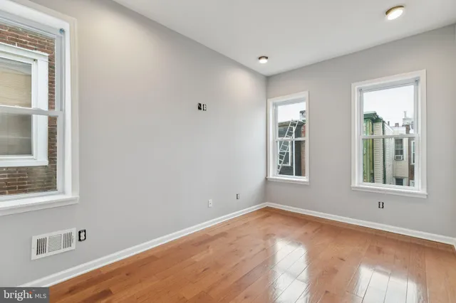 a bedroom with furniture and a floor to ceiling window