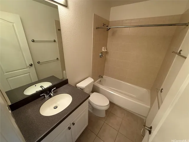 a bathroom with a granite countertop sink toilet a mirror and shower