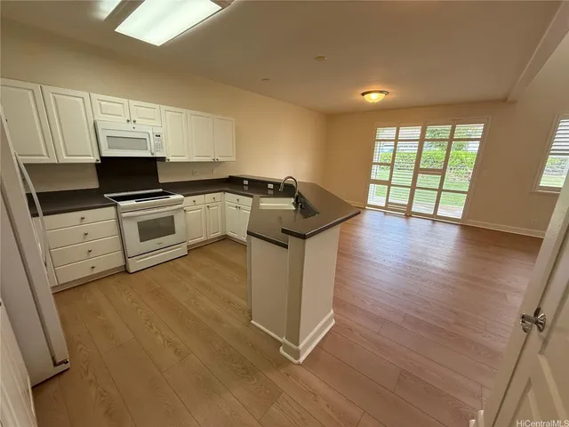 a kitchen with granite countertop a stove and a sink