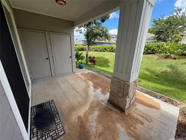 a view of porch with a floor to ceiling window and yard