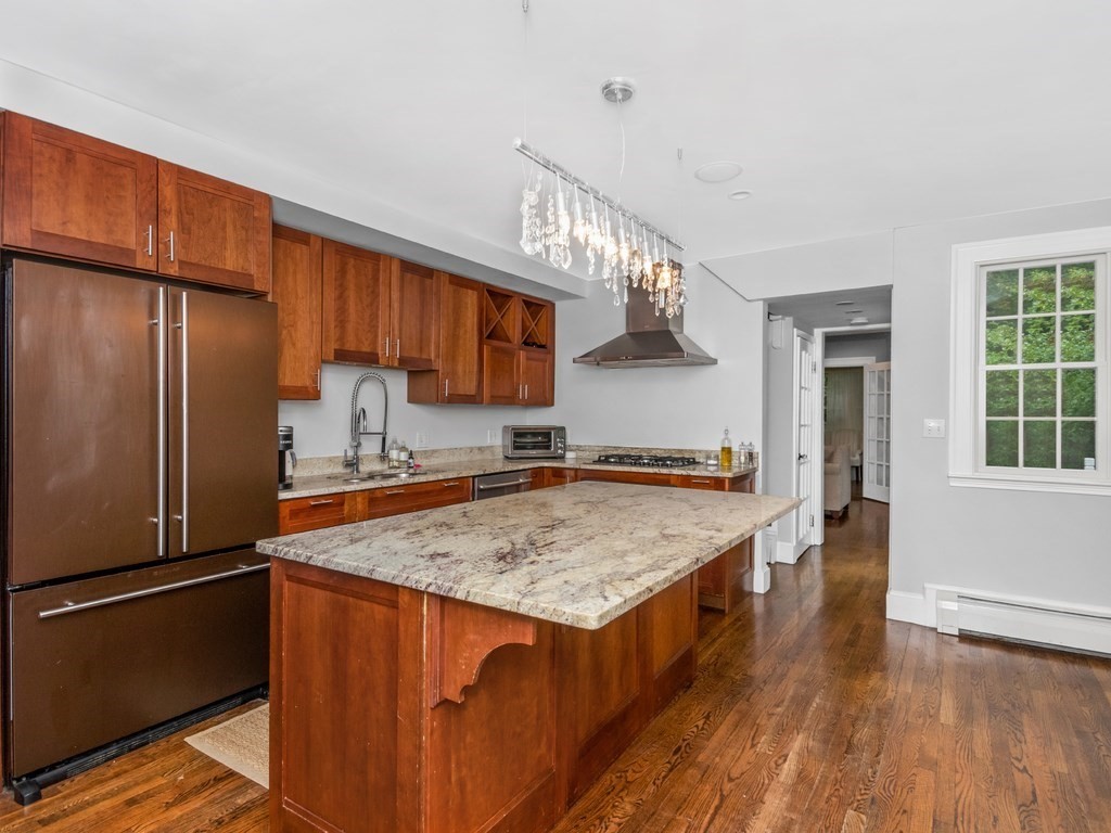 204 Pleasant Street Newton, MA 02459 - Photo 12 of 27 a kitchen with a refrigerator a sink and cabinets
