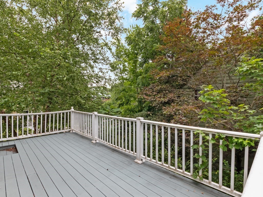 204 Pleasant Street Newton, MA 02459 - Photo 17 of 27 a balcony with wooden floor and fence