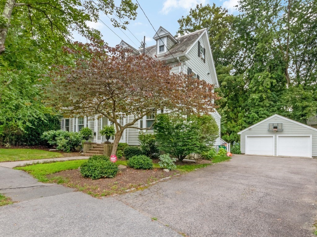 204 Pleasant Street Newton, MA 02459 - Photo 19 of 27 a front view of a house with a yard and garage