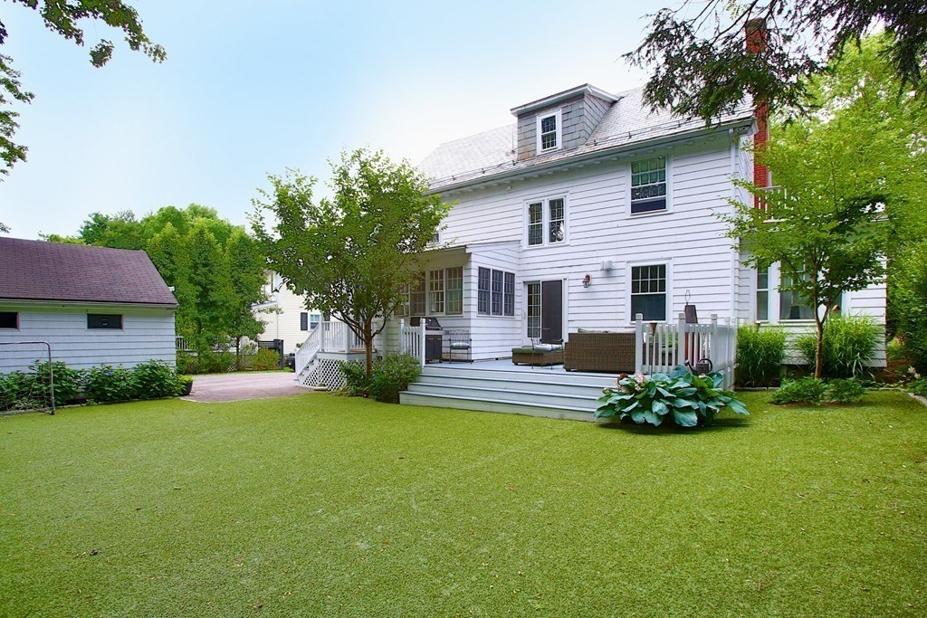 204 Pleasant Street Newton, MA 02459 - Photo 20 of 27 a front view of a house with a garden and yard